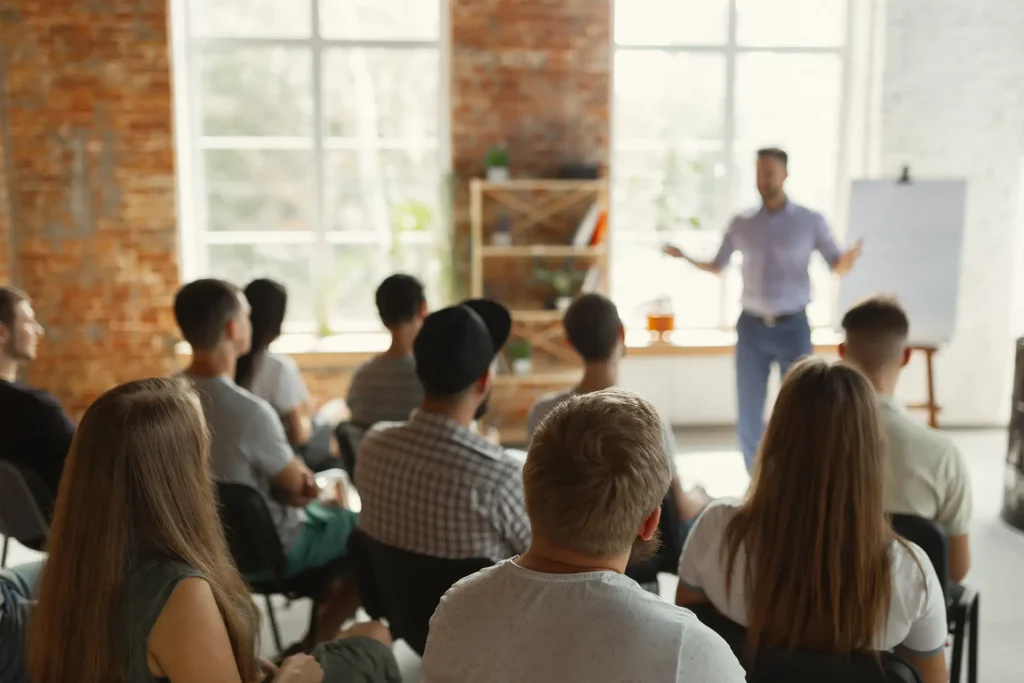 Instructor-led asset integrity training inside a sunlit room with large windows.